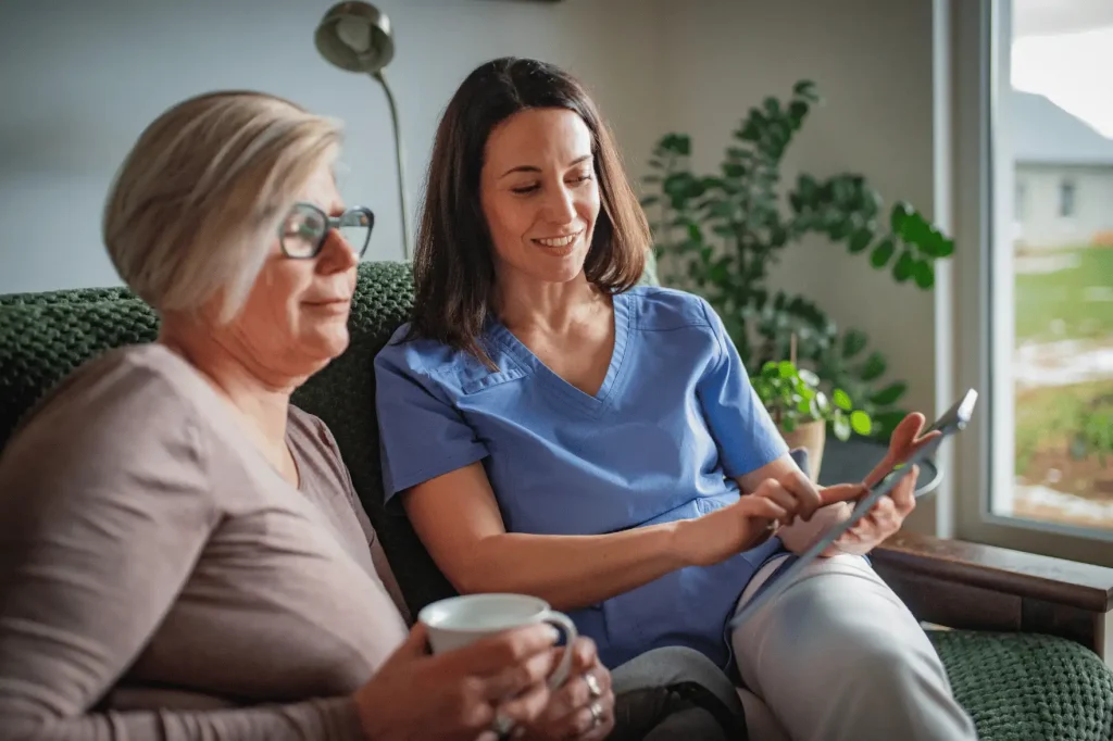 Nurse talking with patient while looking at iPad